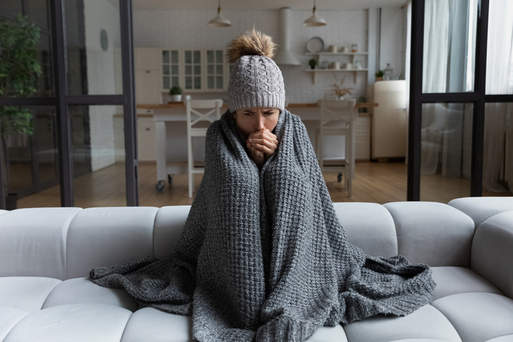 shiver at freezing flat in warm cap blanket